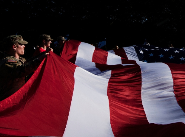 American flag is unfurled during Ole Miss band practice