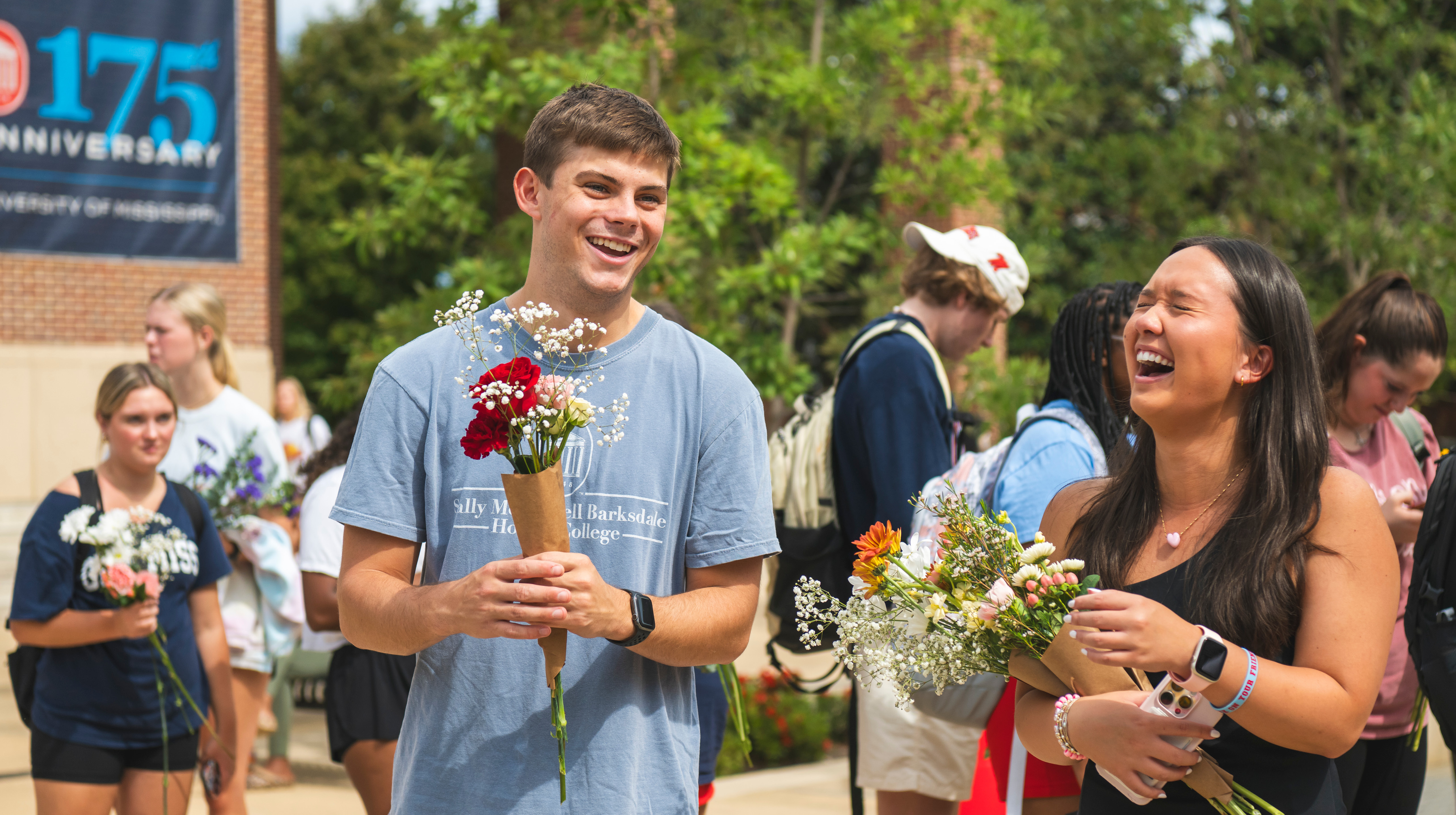 students laughing with flowers