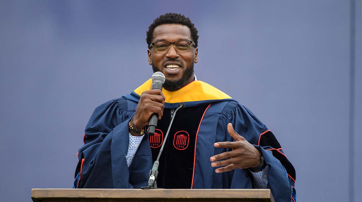 Patrick Willis, Rebel football great and 7-time NFL Pro Bowl selection, addresses to the crowd during graduation.