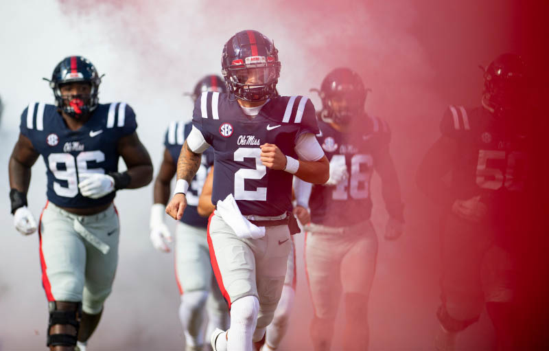 Two Ole Miss football players celebrate on the field.