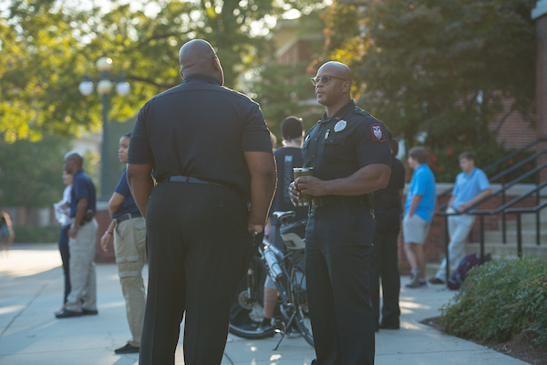 Police officers chat during a coffee with cops event on campus. 