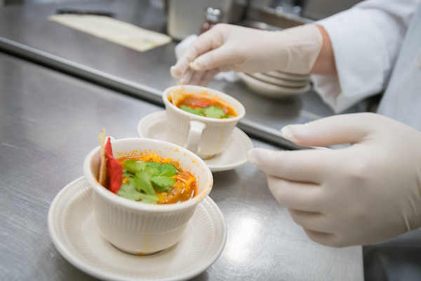 Chef plates food at a campus restaurant. 