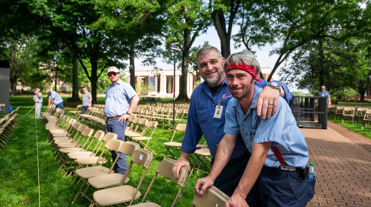 Facilities staff setting up chairs in The Grove