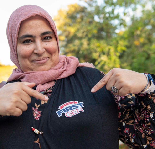 A student shows off her new First Generation student sticker