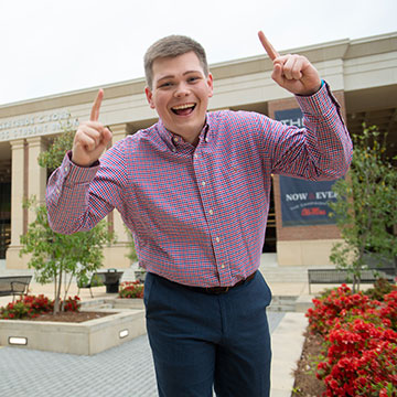 Student celebrates with a big smile on the Union Plaza