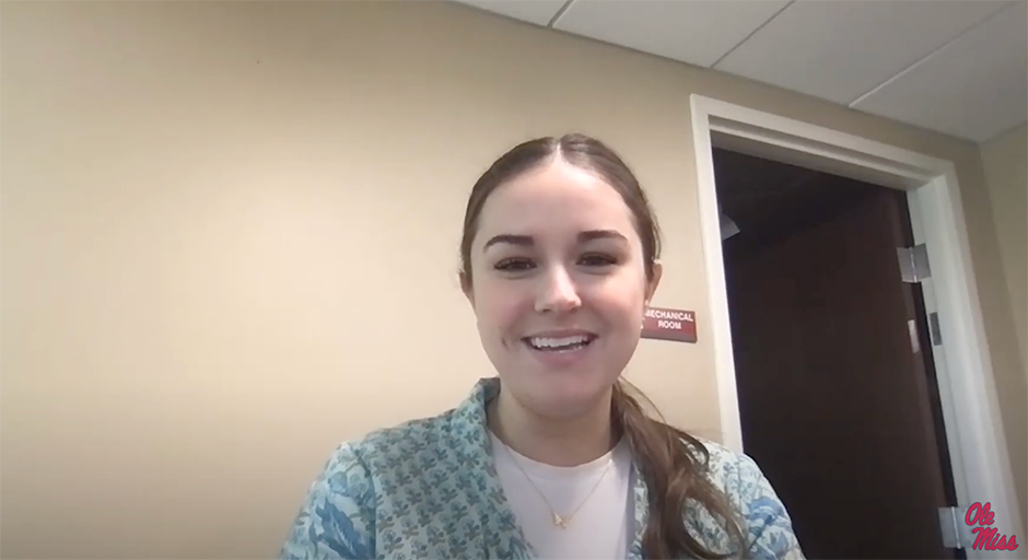 woman with brown hair in ponytail smiling