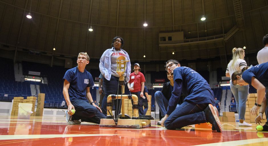 Students reposition their catapult for another chance. 