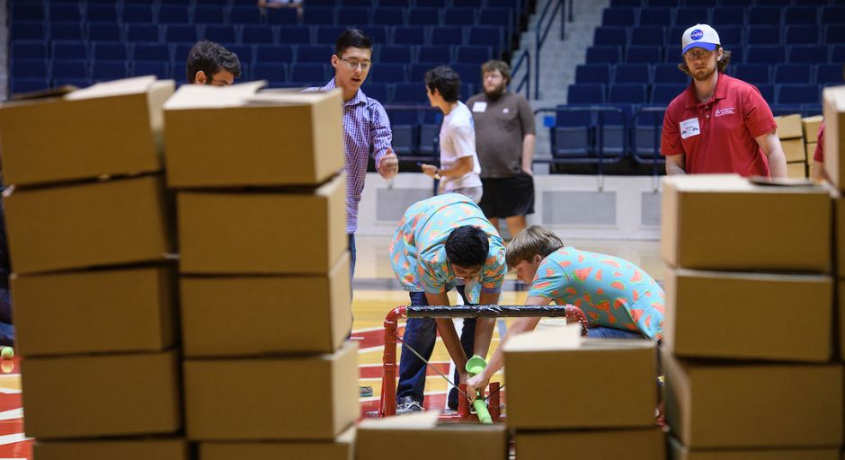 Students reload their catapult after a direct hit. 