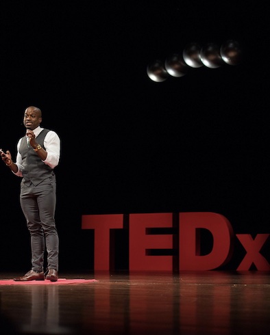 alumnus stands on campus stage to present lecture