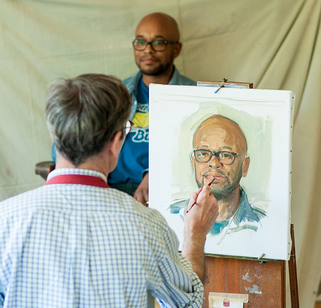 man painting portrait of a man