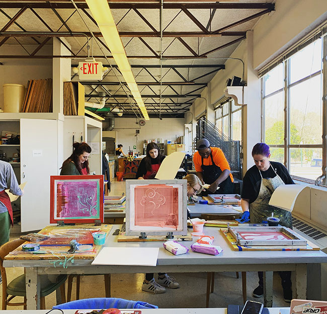 students working in a printshop room