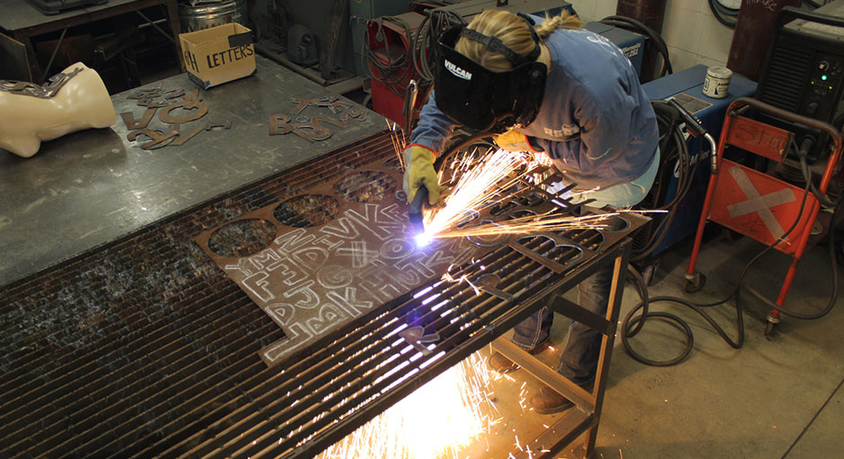 student using plasma cutting machine