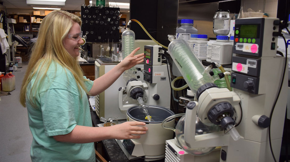 female high school student working with biology equipment