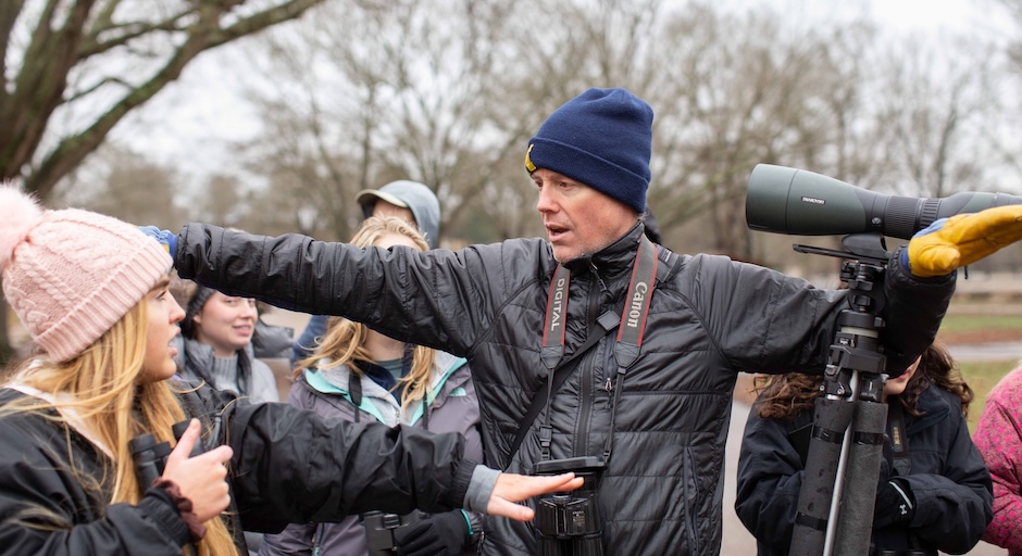 Man spreads his arms while speaking to a girl.