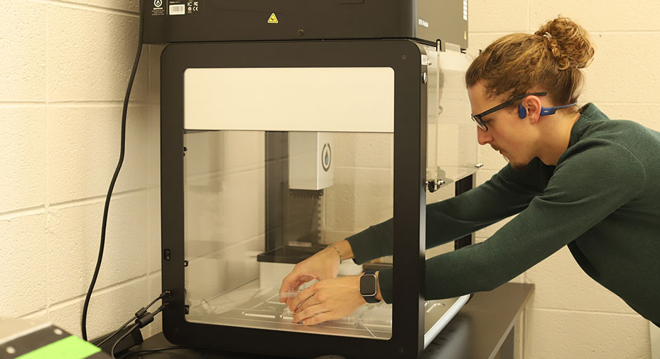 Student using the OT-2 Liquid Handling Robot