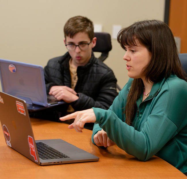 female professor and male student looking at a computer screen