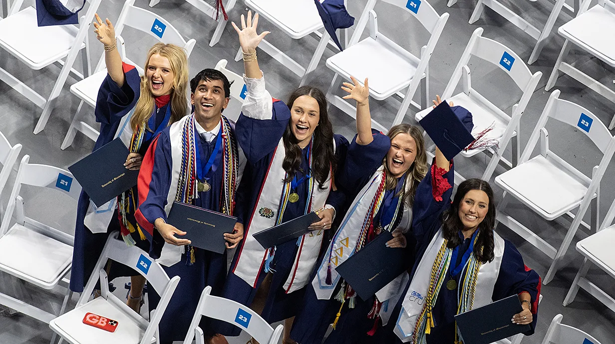 Overhead view of group of students in graduation regalia.
