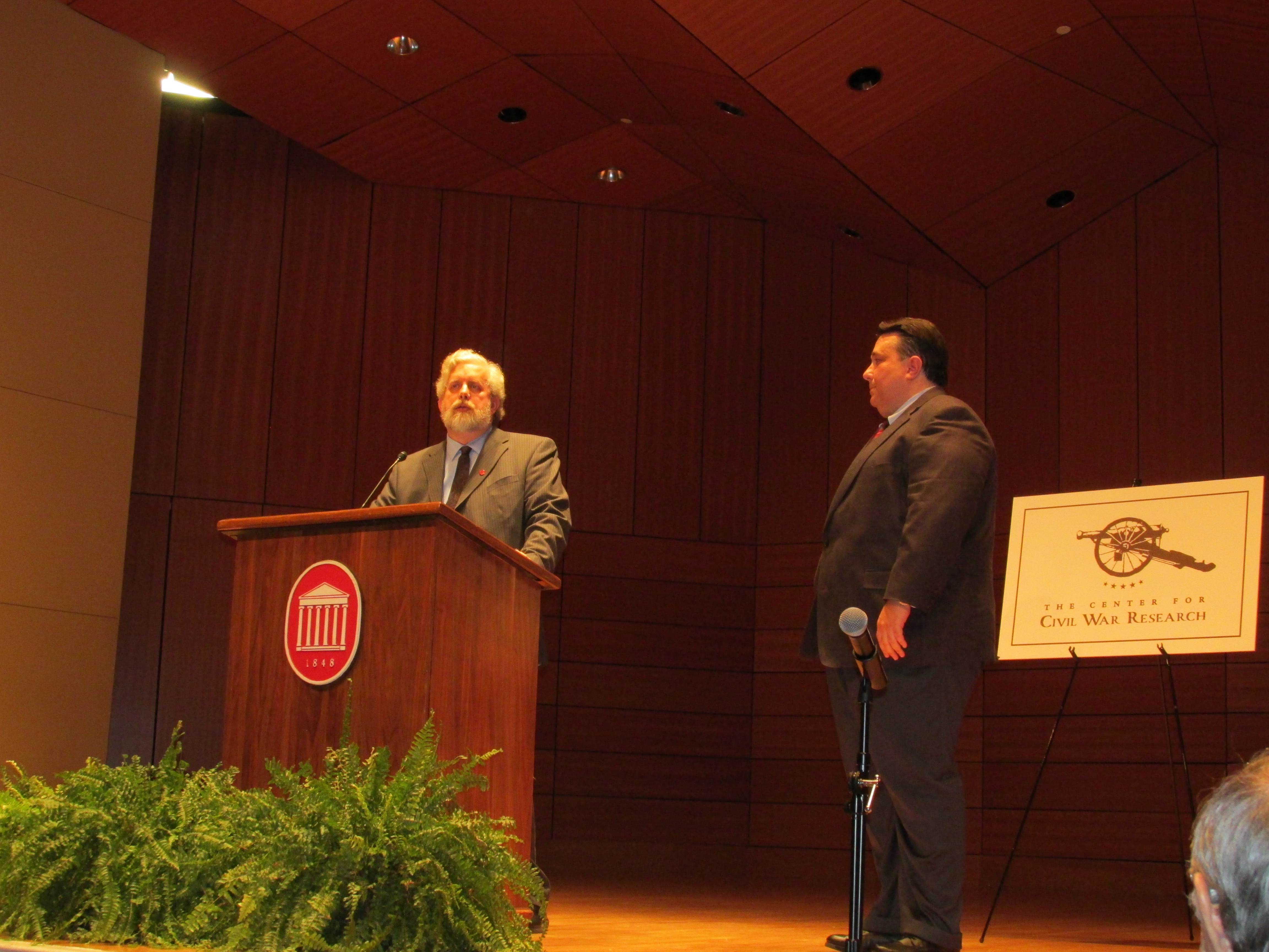 two men standing on a stage