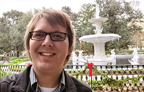 Selfie portrait of Lempke Forsyth Park. Photo taken outside with large fountain in background.