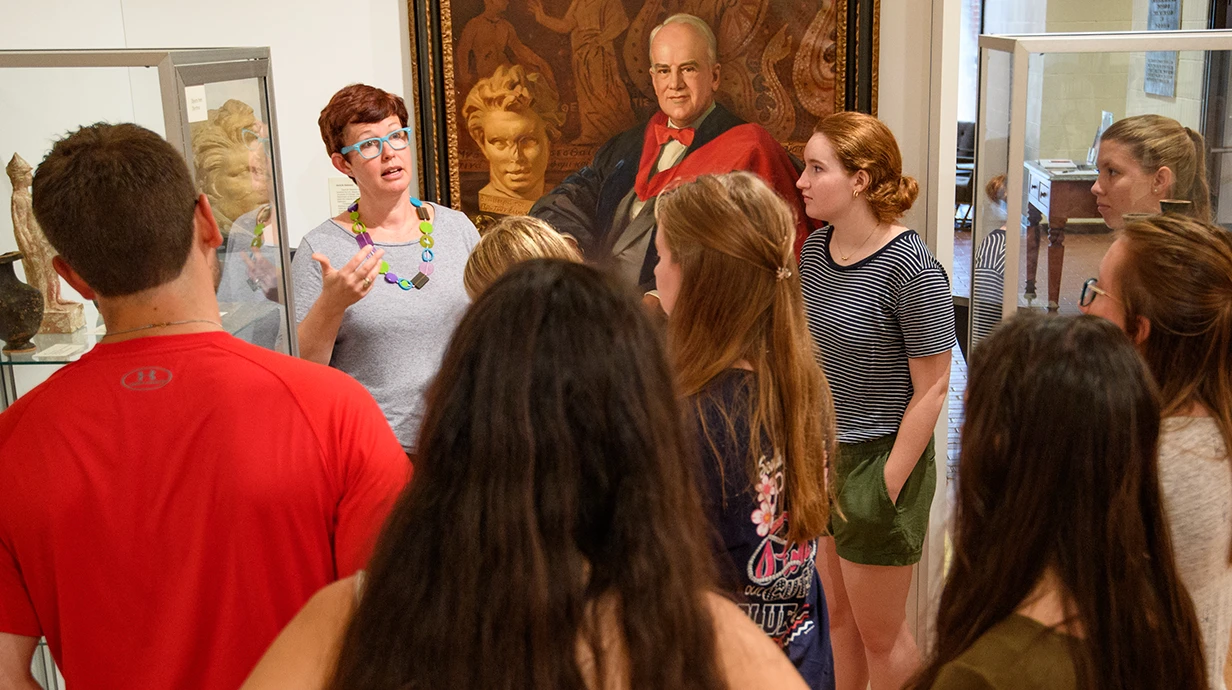 Professor and group of students in museum