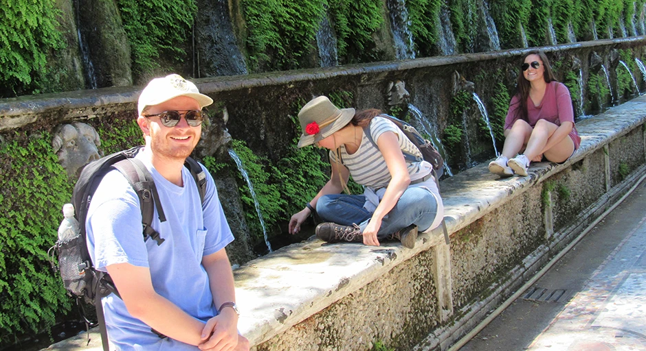 Three students sitting on a wall at VillaD'Este