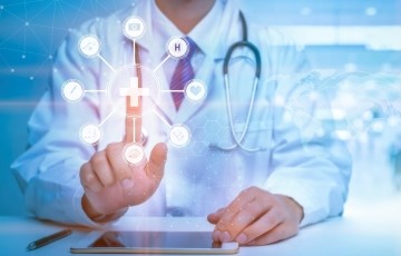healthcare provider reaching forward to touch healthcare symbols floating in space in front of them