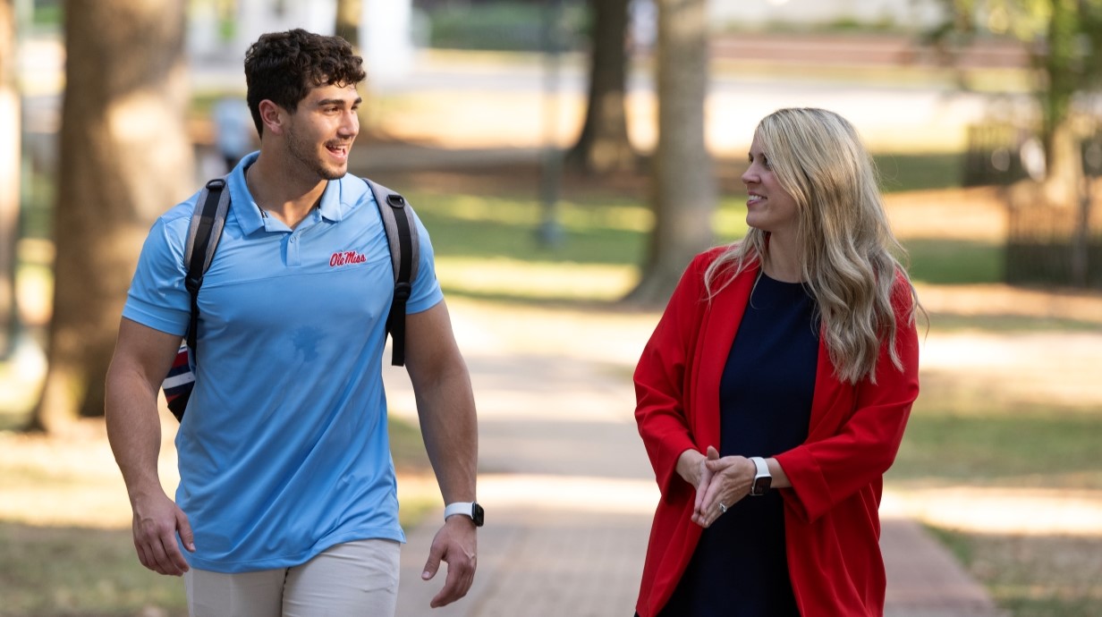 student and advisor walking together and talking