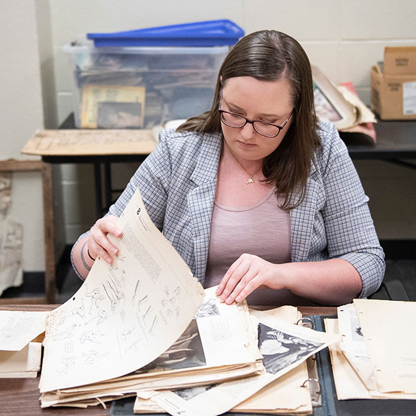 Students reviewing historic manuscripts in Bishop Hall.