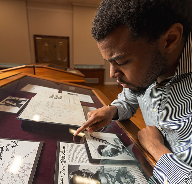 Student reviews historic manuscripts