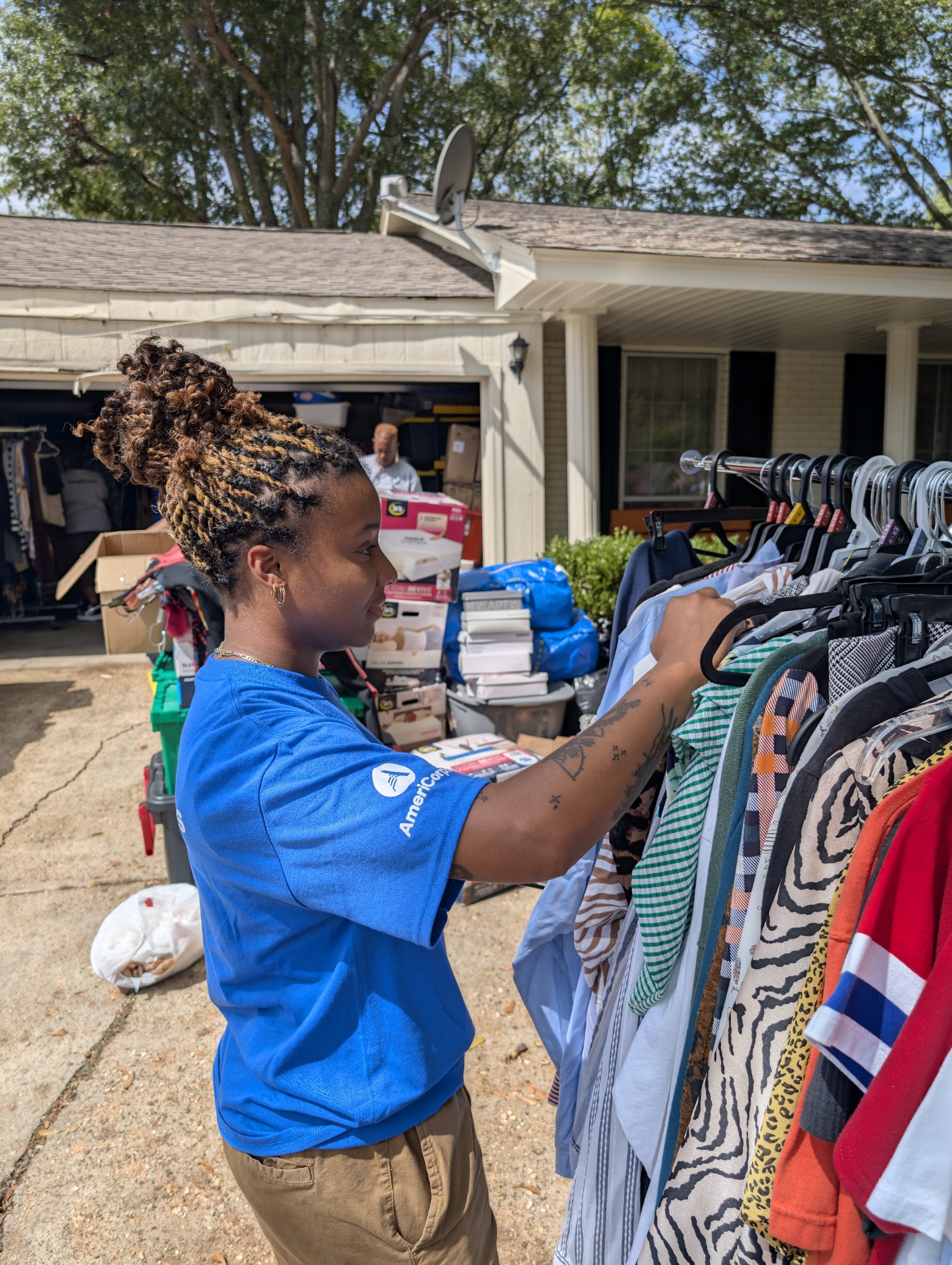 An AmeriCorps member sorts clothes at a national service event.