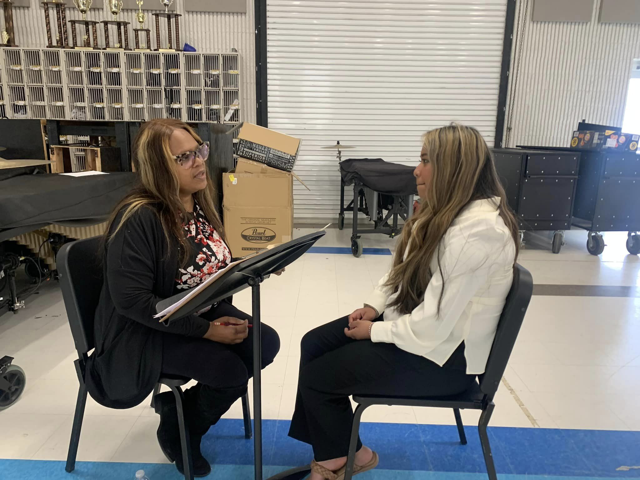 An AmeriCorps member conducts a mock interview with a high school student.