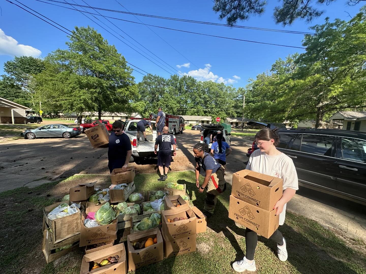 An AmeriCorps member helps gather food with community members to support to the local food pantry.