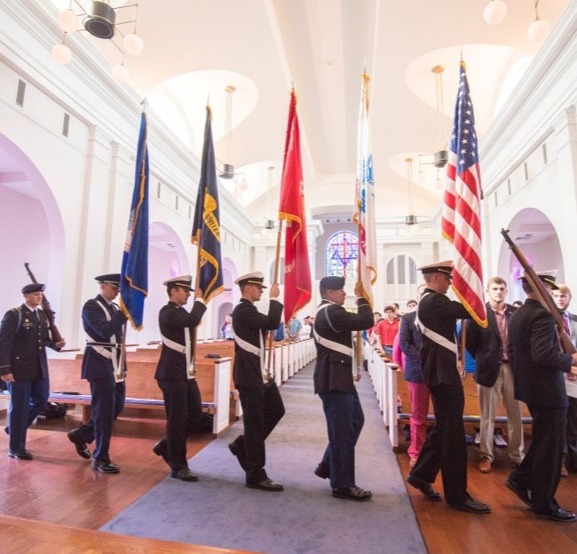 color guard members in the Paris Yates Chapel as part of a ceremony