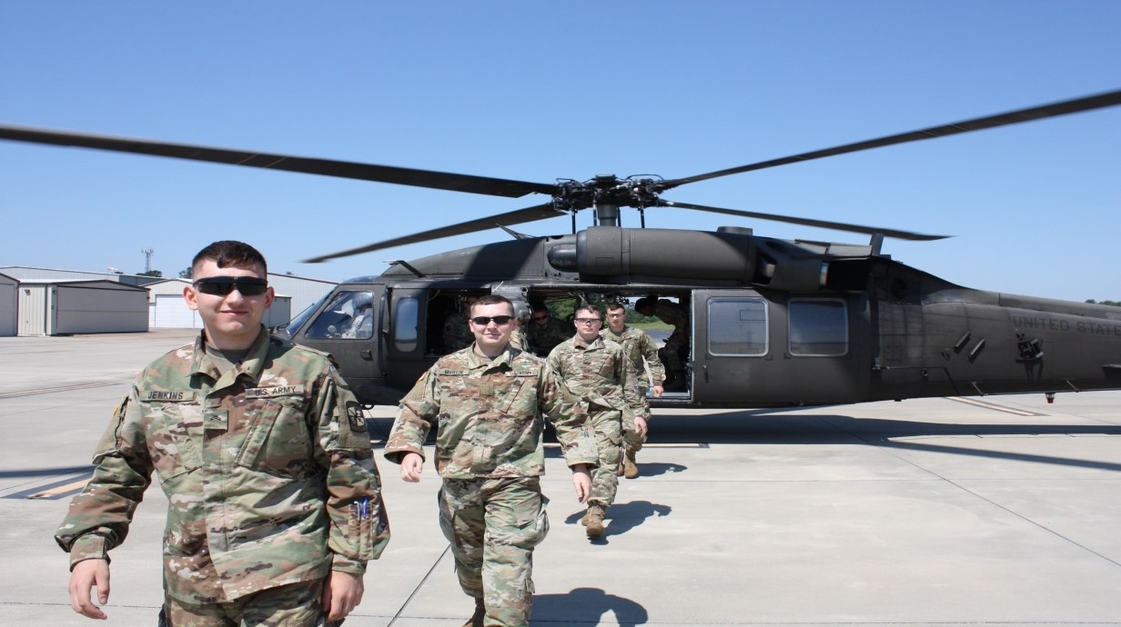 cadets walking off of a helicopter on an army base