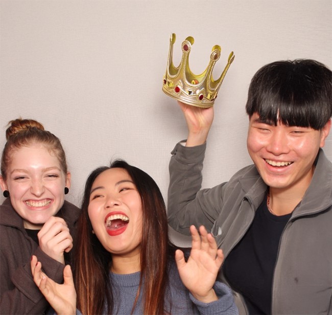 students laughing and standing together for a photo