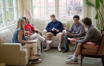 image of a small group of students seated in a lounge area in the Lott building