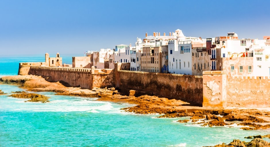 image of a town with a wall on the sea shore