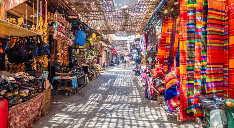 alley of a traditional Moroccan market with colorful gifts