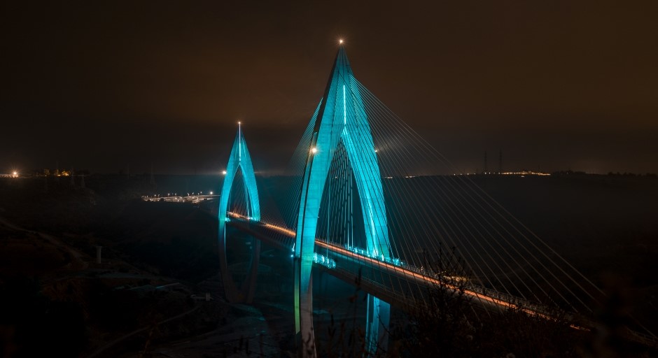 blue lights illuminate a modern bridge 