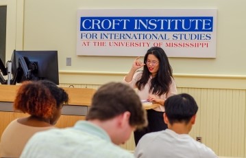 image of a professor teaching in front of a classroom