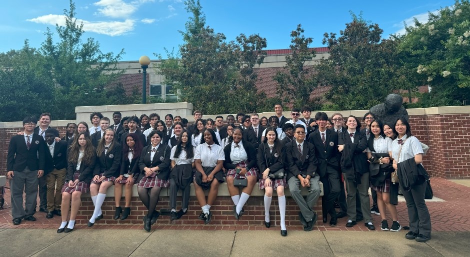 a very large group of students gathered together for a photo on UM campus