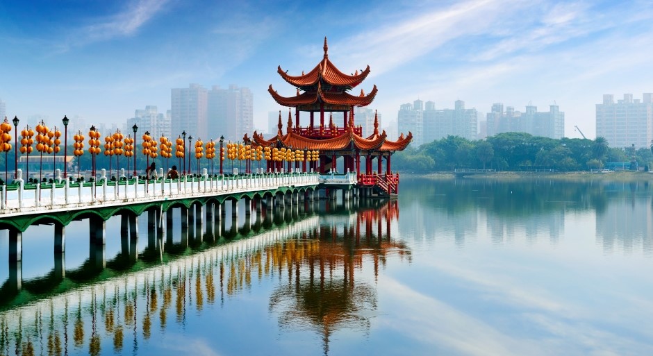 red pagoda in the middle of a lake with a red bridge 