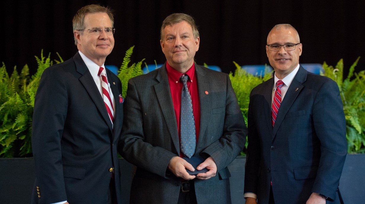 image of Don Dyer accepting an award from Chancellor and Provost