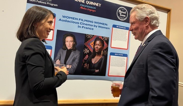 professor talking with Chancellor while standing in front of her research poster