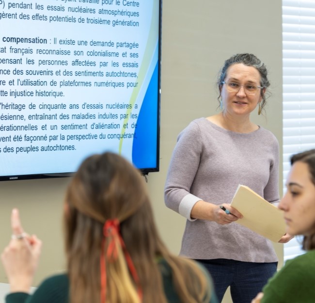 image of a teacher at the front of a classroom 