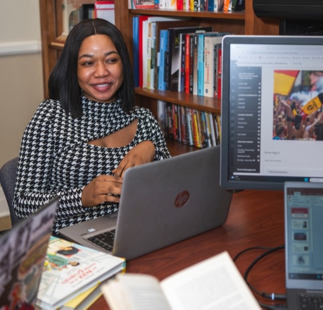 image of a graduate student seated in a faculty office