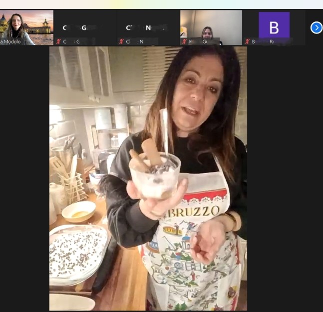 screen capture of a Zoom meeting with someone cooking food in their kitchen