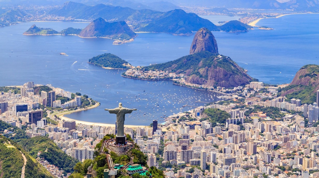 aerial image of Rio de Janeiro, Brazil, showing Christ statue, mountains, and the sea