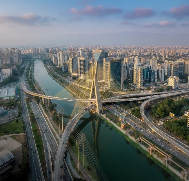 aerial view of Sao Paulo, including a bridge, river, and skyscrapers