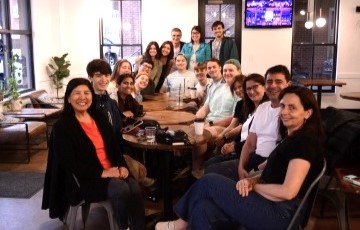 group of students and professor seated together at coffee shop